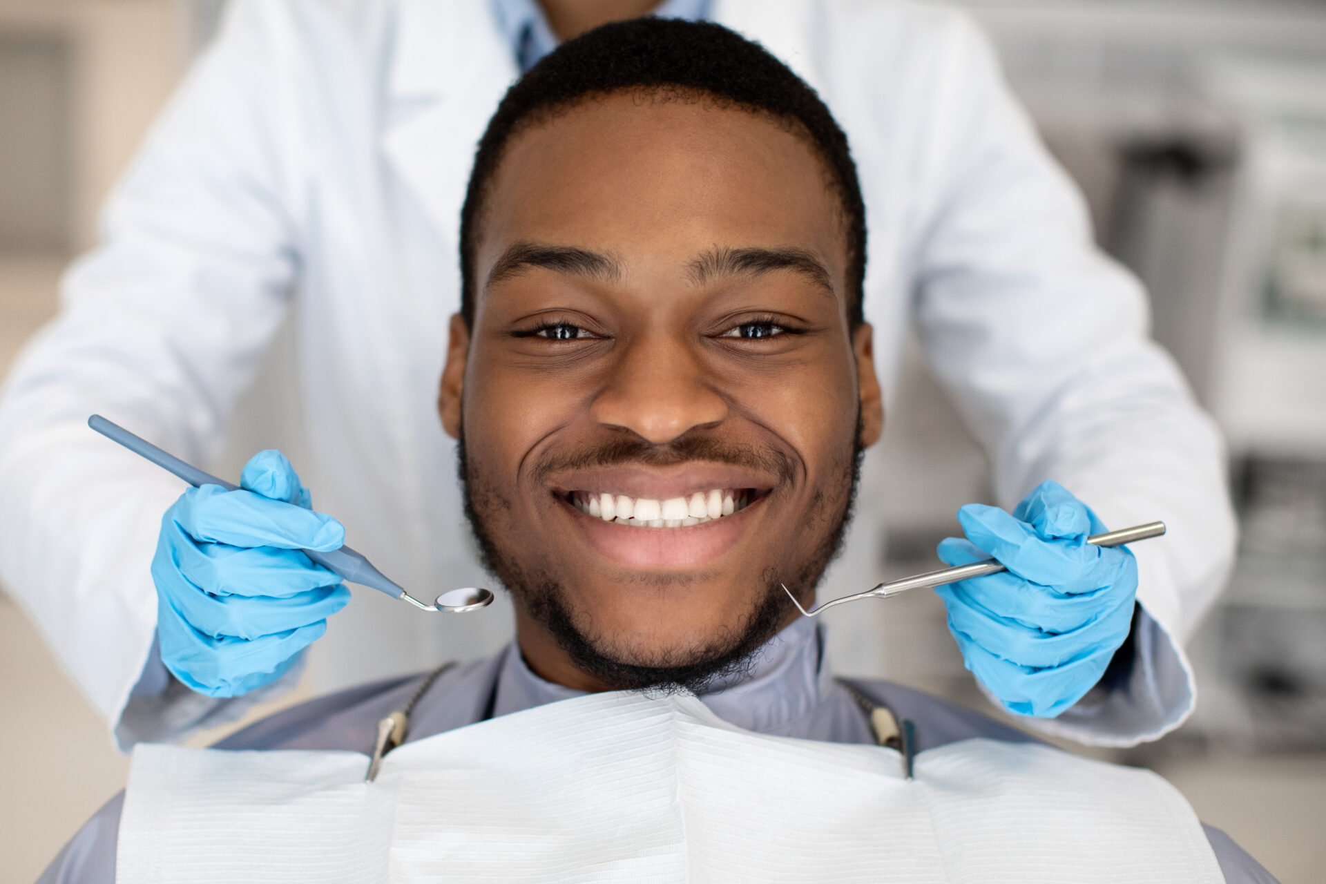 Closeup Of Happy Black Male Patient Getting Dental Treatment In Modern Clinic